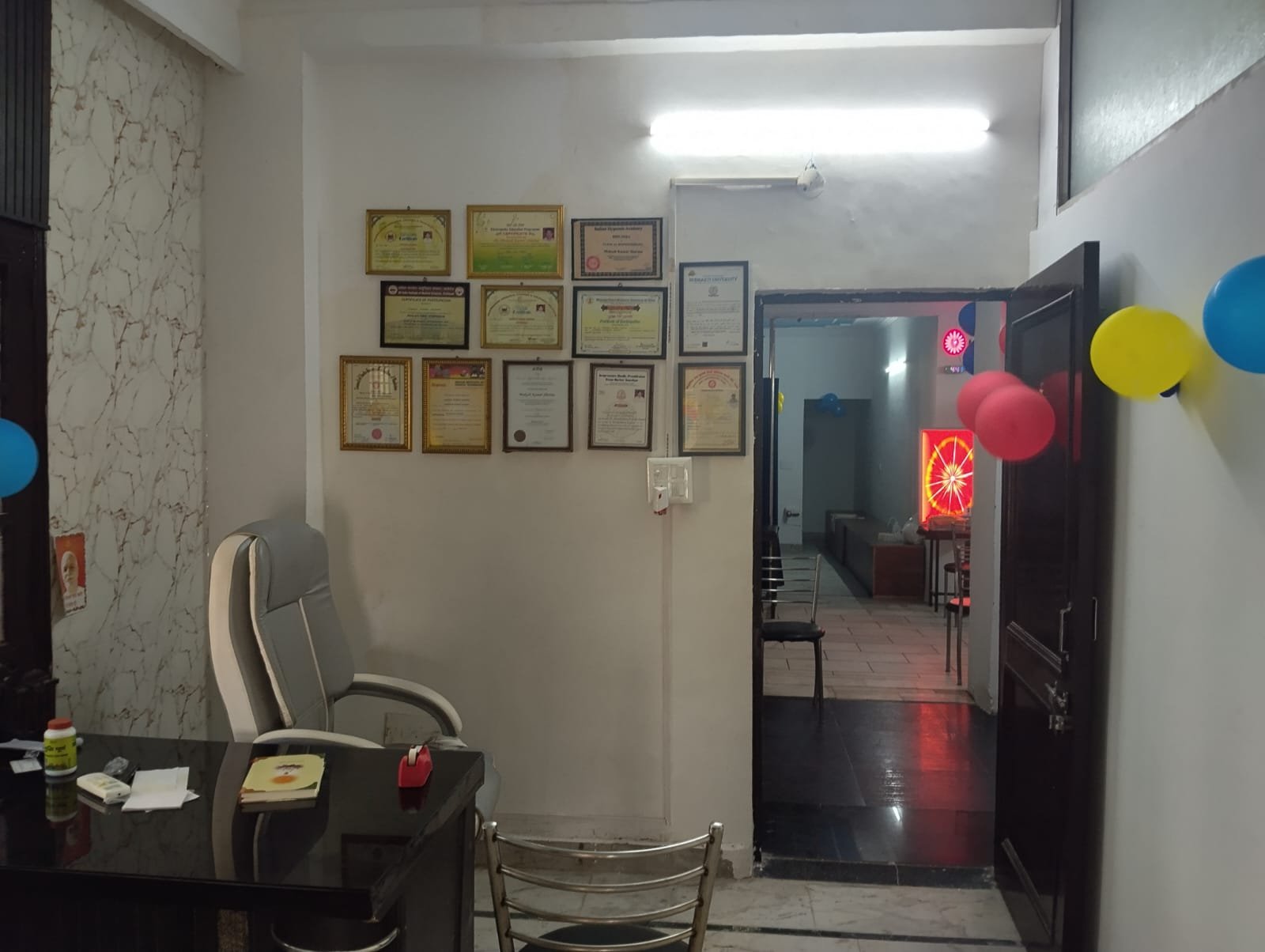 Consultation cabin with Dr. Sharma's framed certificates on the wall