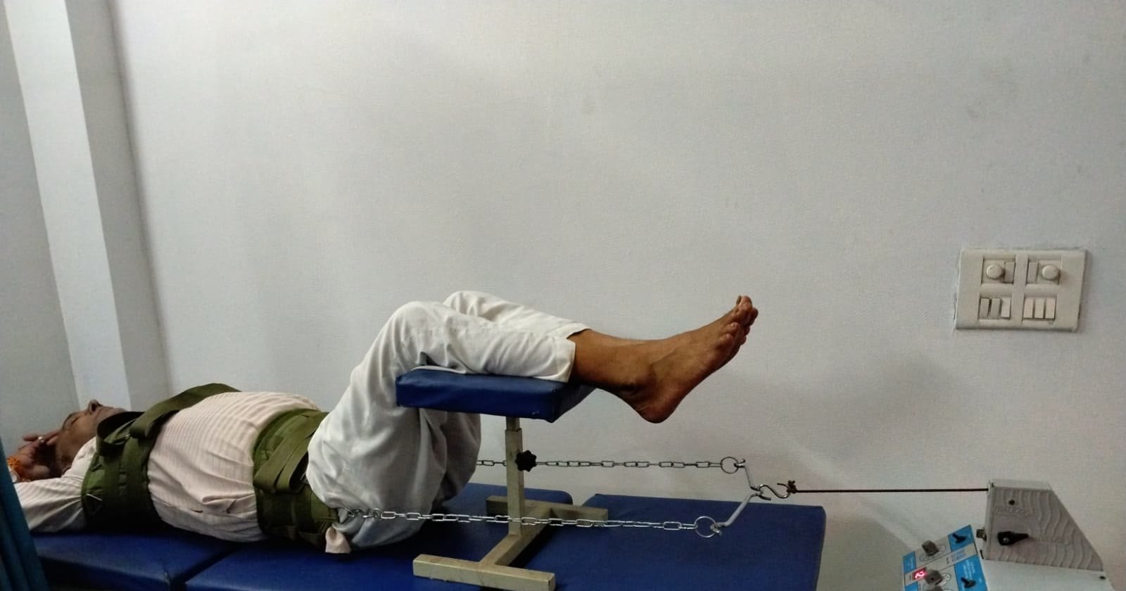 Patient receiving lumbar traction on a treatment table