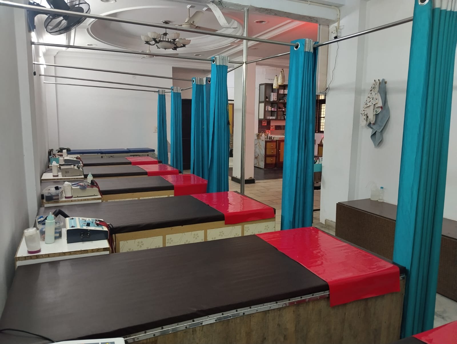 Row of physiotherapy beds with electrotherapy units beside each bed